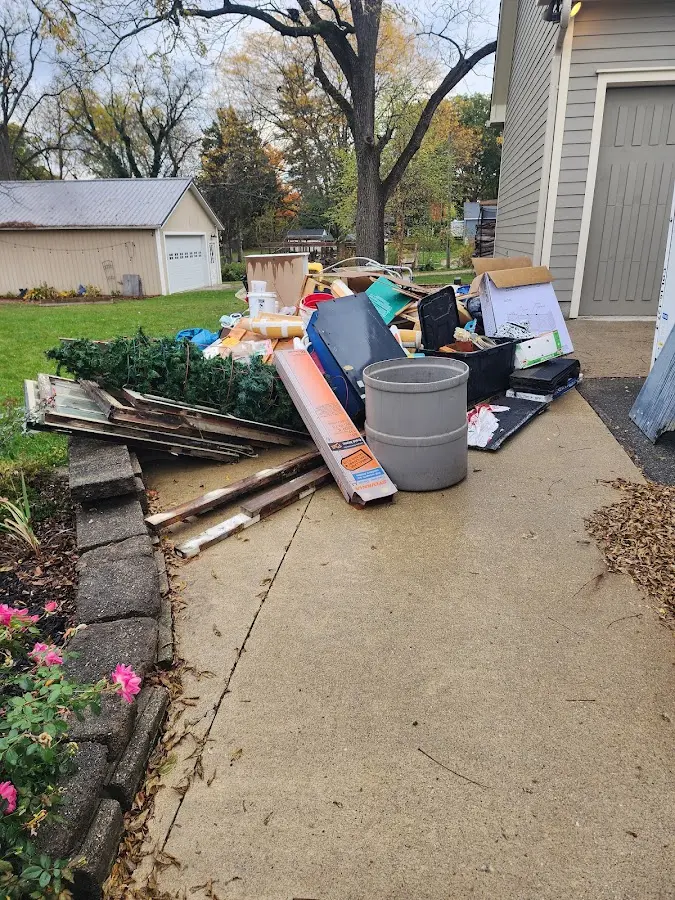 Dumpster being loaded with debris for 12 Yard Dumpster Rental in Pecan Acres
